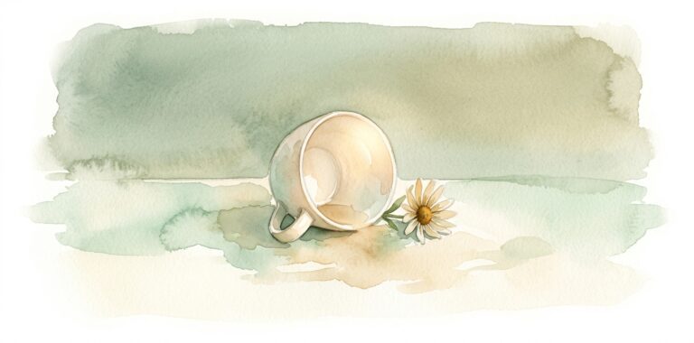 Empty ceramic cup in a dream tipped gently on its side beside a wildflower on a cream surface in soft sage light